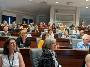 A group of people sitting in a lecture hall.