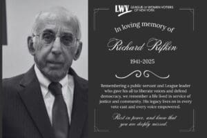 Elderly man in a suit next to a memorial card reading, "In loving memory of Richard Rifkin 1941-2025," with a tribute from the League of Women Voters of New York.